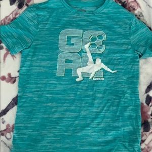 a blue reebok soccer shirt